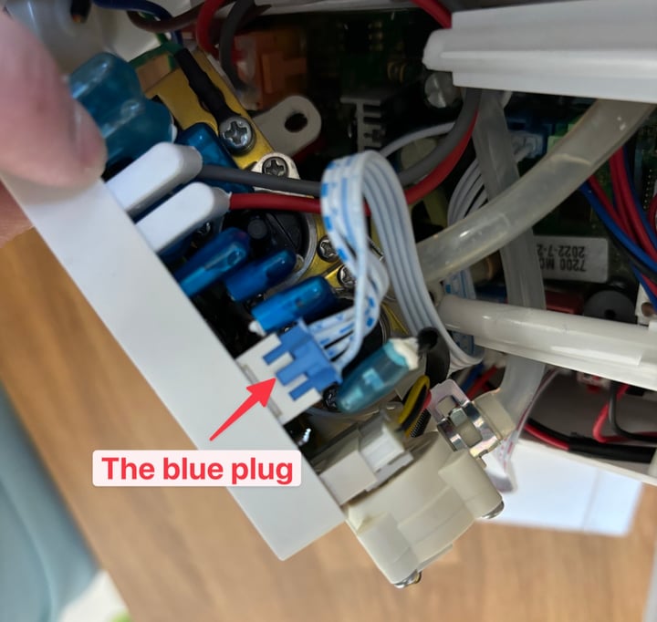 Field-service reference photo of instant-heating module signal connector